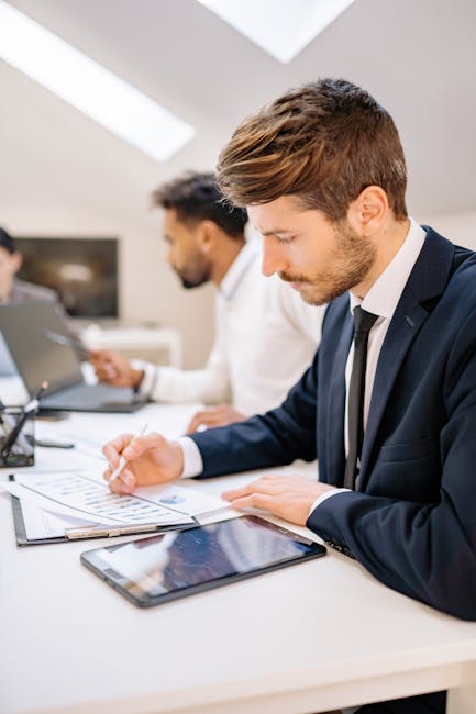 Professionals doing desk stretches in modern office